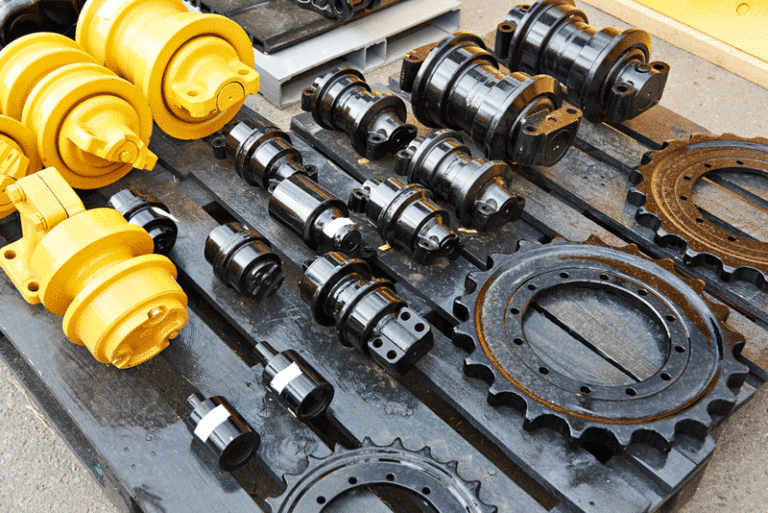 heavy equipment parts lying on wooden pallet